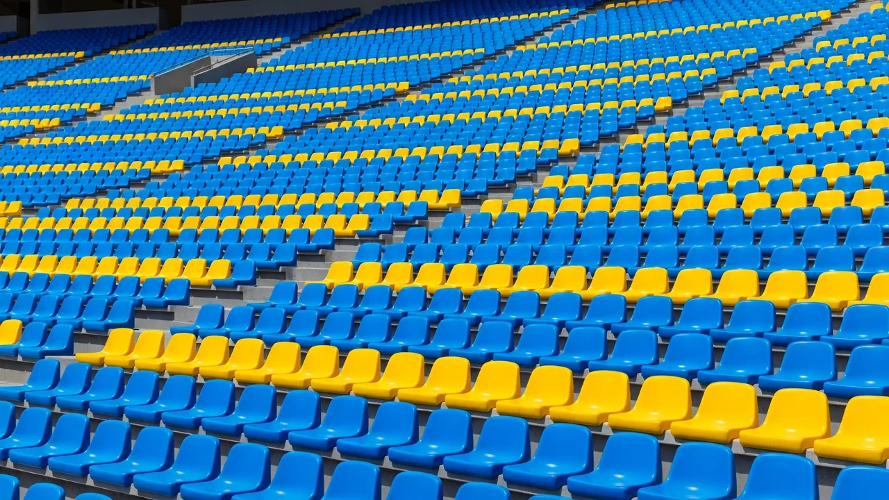 Football stadium seats in vivid blue and yellow rows in sunlight